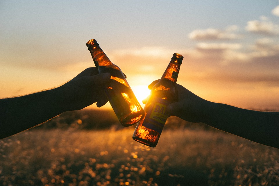 holding bottles of beer